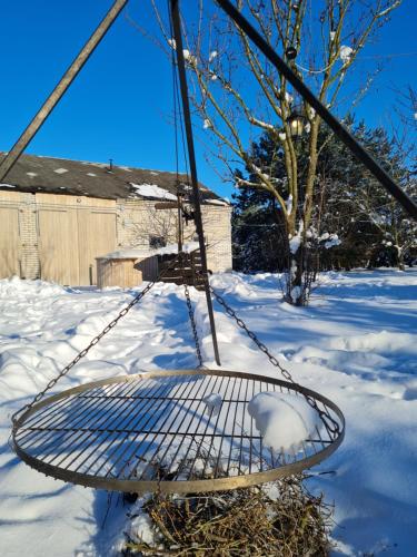 a swing in the snow in a yard at Siedlisko Bolek in Nadrybie