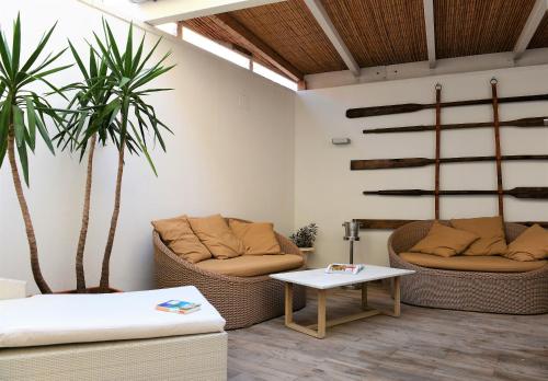 a living room with two couches and a table at The Old Bakery in Cagliari