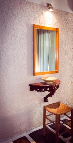 a bathroom with a sink and a mirror on a wall at Apollonia Hotel Apartments in Varkiza