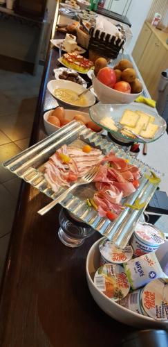 a buffet line with many different types of food at Savoy Hotel & Restaurant in Saint-Michel-de-Maurienne