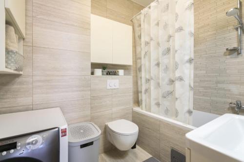 a bathroom with a toilet and a sink at Apartment SARA - free parking for 2 cars in Zagreb