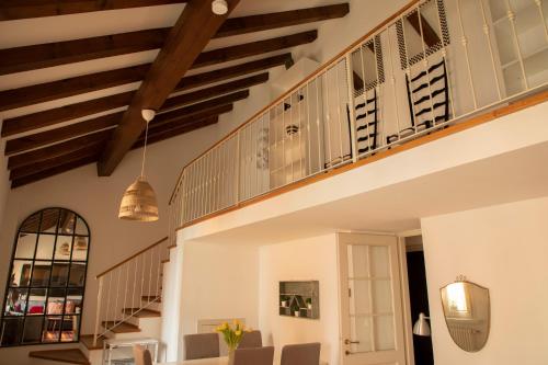 a living room with a staircase and chairs at Alla Piazzetta del Castello in Cernobbio