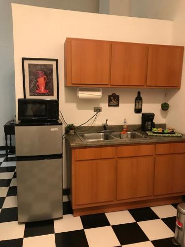 a kitchen with a sink and a refrigerator at 310Guest-House La Vida in San Juan