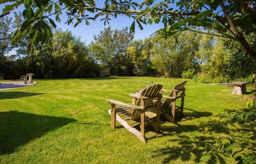 two chairs and a picnic table in a park at Erw Fach in Valley