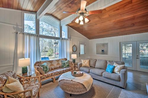 a living room with a couch and a table at Waterfront Foley Area Home - 15 Mi to Gulf! in Elberta