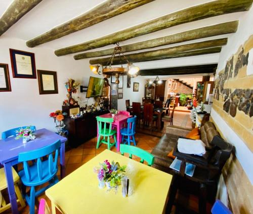 a living room with tables and chairs and a room with at Hotel - Hospedería Villa Palva in Villa de Leyva