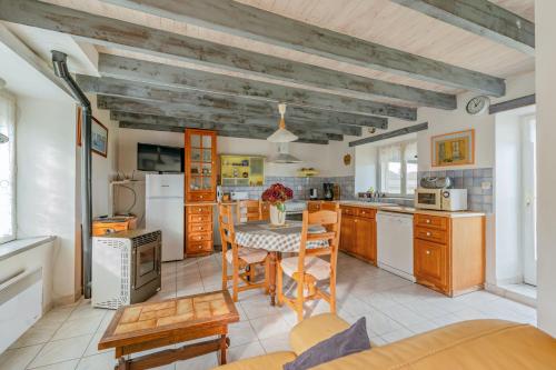 une cuisine avec une table et des chaises dans une pièce dans l'établissement Maison charmante avec vue sur la mer à Paimpol, à Paimpol