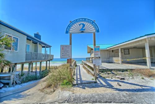 a clock on the beach next to a building at Aqua View Motel in Panama City Beach
