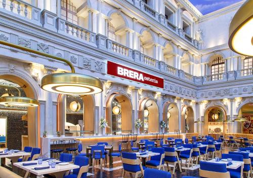 a restaurant with blue tables and chairs in a building at The Palazzo at The Venetian® in Las Vegas