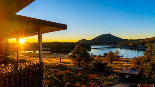 a view of a lake at sunset from a house at Quiet Mind Mountain Lodge, Retreat & Spa in Julian