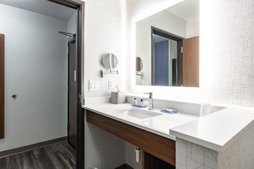 a bathroom with a sink and a mirror at Holiday Inn Express & Suites - Moundsville by IHG in Moundsville