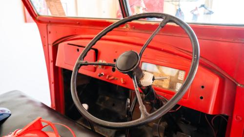 a steering wheel of a red bus at Fire Station Inn in Adelaide