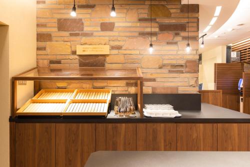 a restaurant counter with a stone wall at Washington R&B Hotel Higashi Nihonbashi in Tokyo