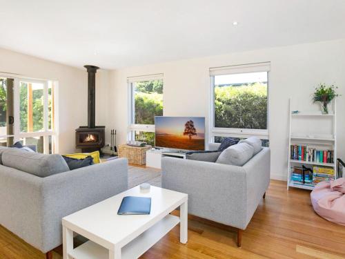 a living room with two couches and a tv at Within Oceans Reach in Cape Woolamai