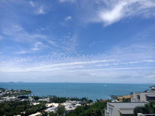 a large body of water with a city at Whitsunday Reflections in Airlie Beach