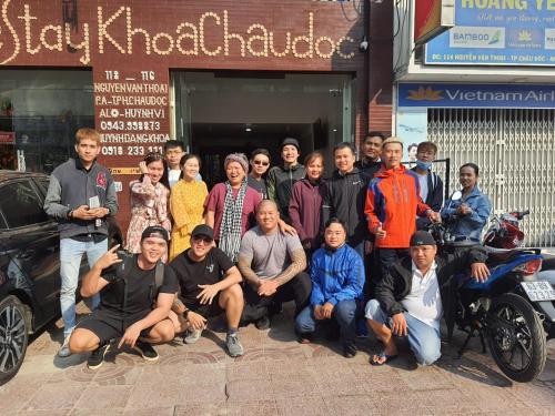 a group of people posing for a picture in front of a building at Homestay Khoa Chaudoc in Chau Doc