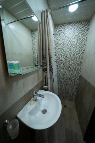 a bathroom with a sink and a mirror at Woodland cottages in Tsaghkadzor