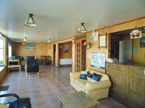 a living room with a couch and a table at Nikos II Adventure in Puerto Natales