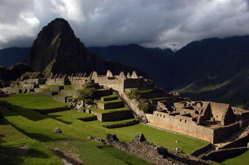 an old castle with a mountain in the background at Machupicchu Lodging in Machu Picchu