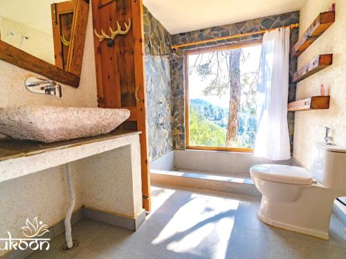 a bathroom with a sink and a toilet and a window at Sukoon BluSalzz Escapade, Bhatrojkhan, Near Ranikhet, Uttarakhand in Tota Ām