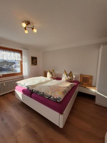 a bedroom with a bed and a window at Landhaus Bindermoos in Schönau am Königssee