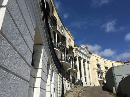 a building with a fence on the side of a street at Moray Hastings in Hastings