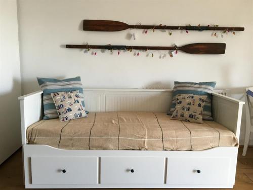 a white bed with pillows on top of it at Moray Hastings in Hastings