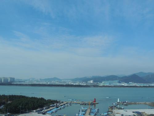 a view of a harbor with boats in the water at Hotel OU in Busan