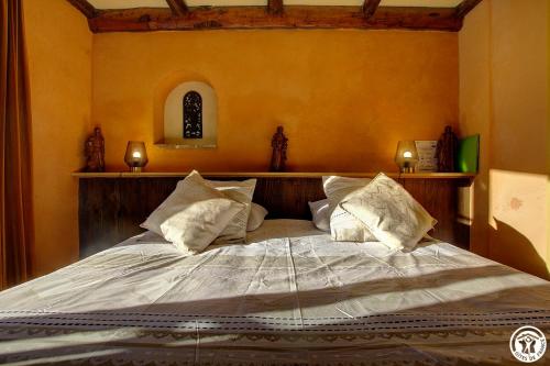 a bedroom with a large bed with pillows on it at Goute la vie in Marchamp