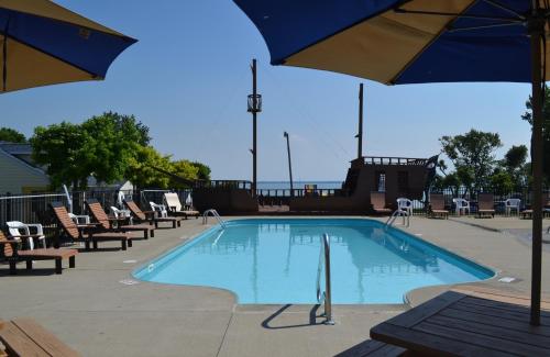 a swimming pool with chairs and an umbrella at South Beach Resort Hotel in Marblehead