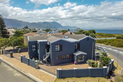 a blue house on the side of a road at The Whale's Tale Guesthouse in Hermanus