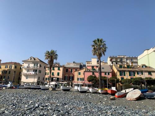 a group of boats are lined up on a rocky beach at Casa Marino by Holiday World in Cogoleto
