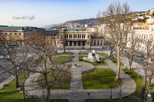 a view of a city with a fountain and buildings at Casa del Caffè in Trieste