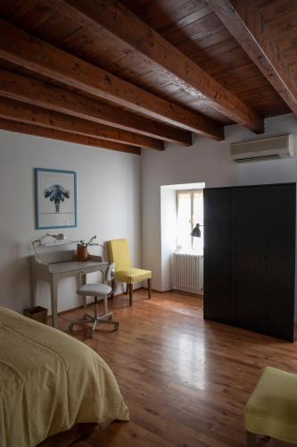 a bedroom with a bed and a desk and a table at Alla Piazzetta del Castello in Cernobbio