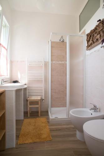 a bathroom with a shower and a toilet and a sink at B&B La casa dei gelsi in Loano