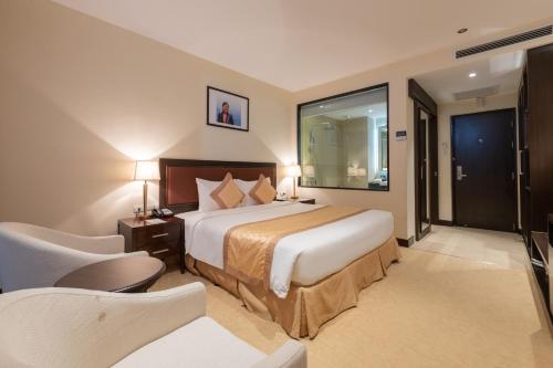 a hotel room with a large bed and a window at Red River View Hotel in Lao Cai