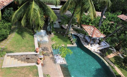 an aerial view of a swimming pool in a resort at The Spice House Mirissa in Mirissa