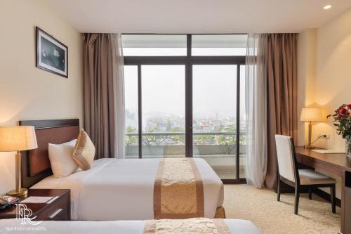 Ένα ή περισσότερα κρεβάτια σε δωμάτιο στο Red River View Hotel