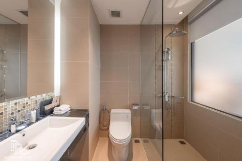 a bathroom with a toilet and a sink and a shower at Red River View Hotel in Lao Cai