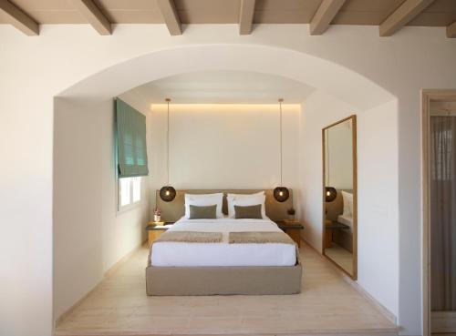a bedroom with a large bed and a large mirror at Vencia Boutique Hotel in Mýkonos City