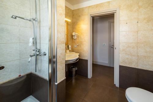 a bathroom with a shower and a toilet and a sink at Best Western Plus Hotel Perla Del Porto in Catanzaro Lido