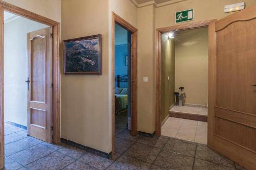 a hallway with a bathroom with a walk in shower at Casa Rural Ca Lluis in La Vall de Laguar