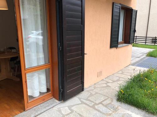 a door to a house with white cups in it at I Cirmoli in Bormio
