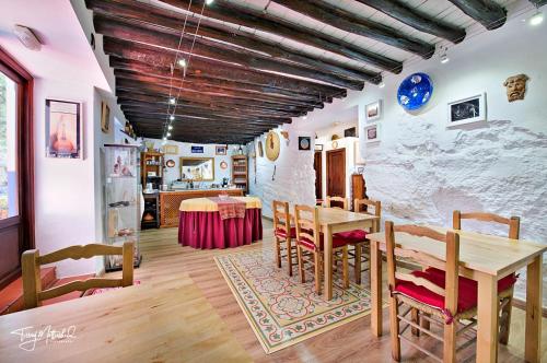 Un comedor con una mesa y una pared de piedra. en La Seguiriya, en Alhama de Granada