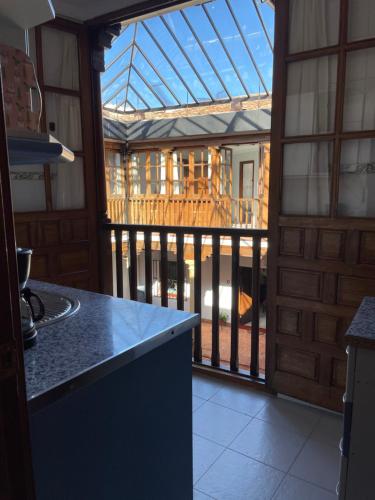 eine Küche mit einer abgeschirmten Veranda mit einem Haus in der Unterkunft Apartamentos Centro del VINO Tandal in Ronda