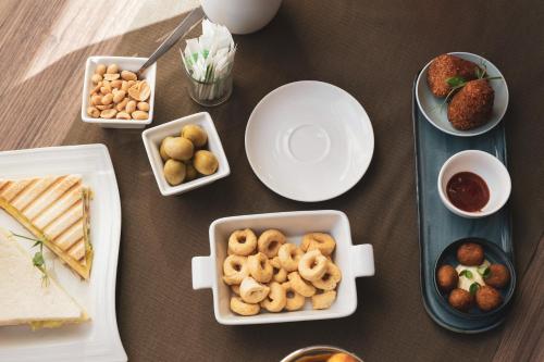 a table topped with plates and bowls of food at Best Western Plus Hotel Perla Del Porto in Catanzaro Lido