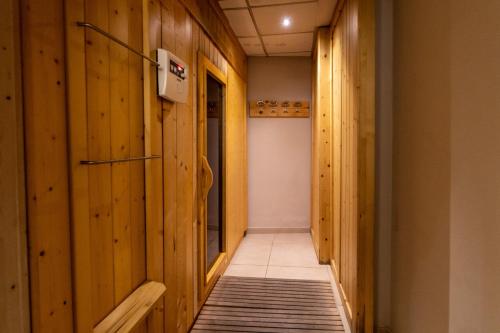 a hallway with wood paneled walls and a tile floor at Best Western Plus Hotel Perla Del Porto in Catanzaro Lido