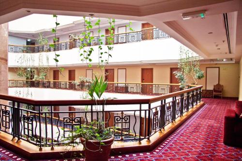 a lobby with potted plants in a building at Regent Palace Hotel in Dubai