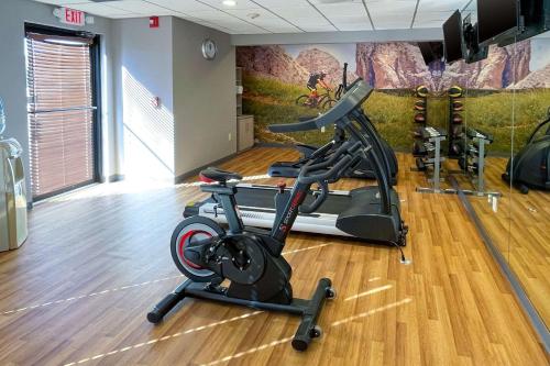 a gym with a treadmill and exercise bike in a room at Clarion Pointe Near University in Rock Hill