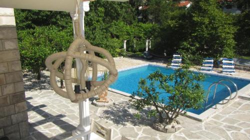 a swimming pool with aotation ring in front of a resort at Villa D'amore Montenegro in Donji Morinj